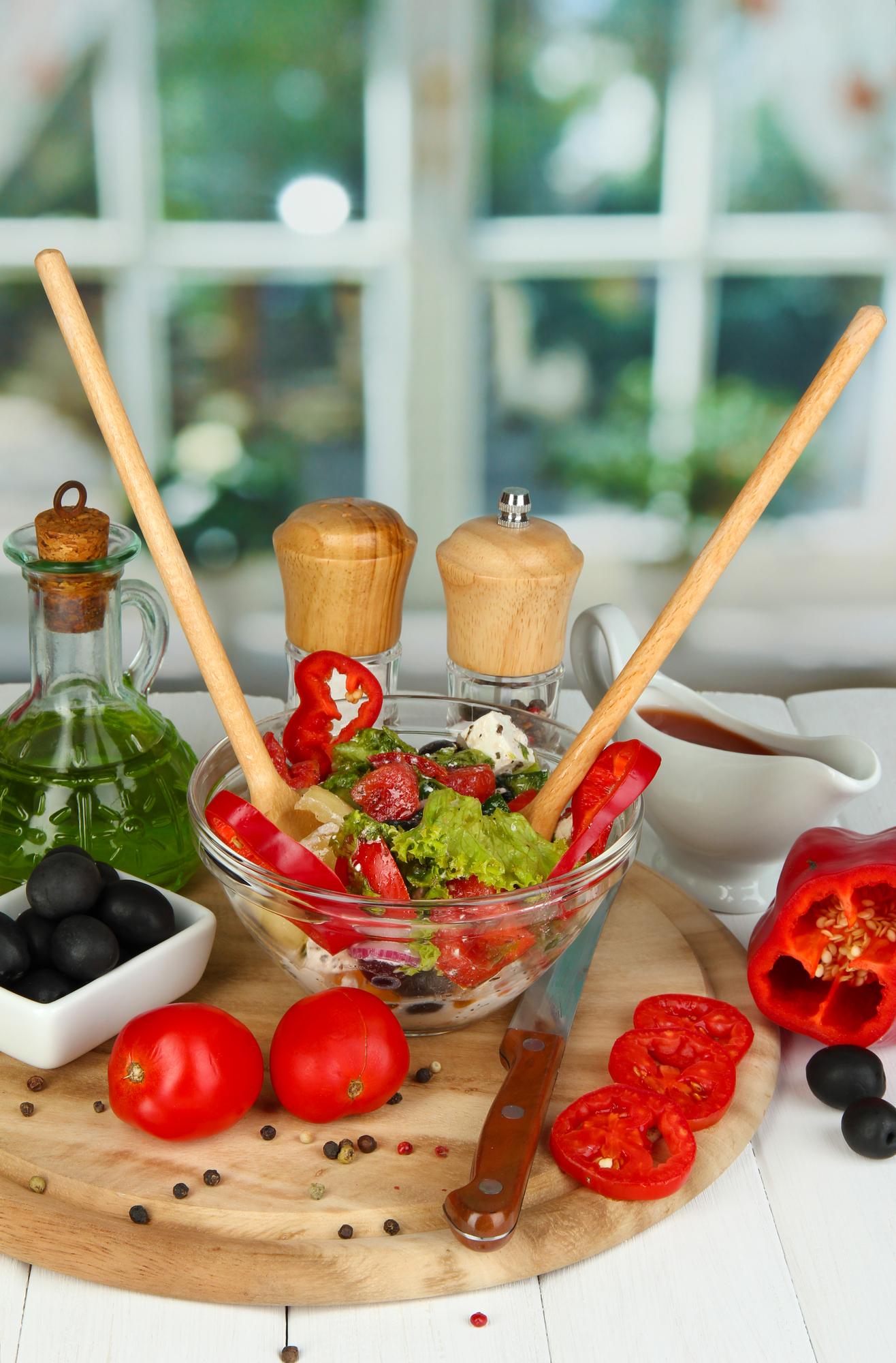 Bowl with prepared quick salad and utensils